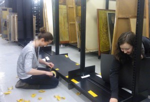 Volunteers, lining shelves with Plastazote to protect paintings stored at the Library Annexe