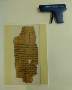 Papyrus fragment rehoused in polyester and mountboard frame with zerostat gun