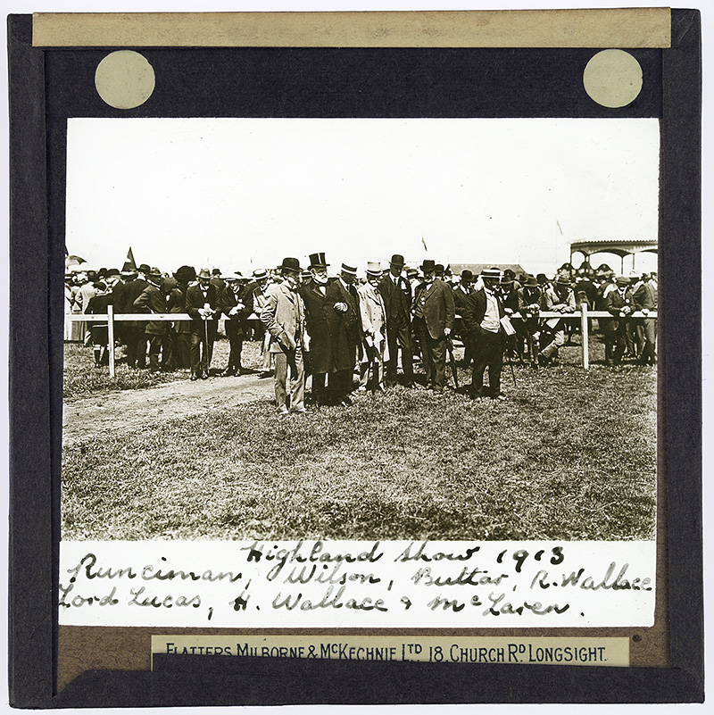 Photograph of a group of men: Runciman, Wilson, Buttar, R[obert] Wallace, Lord Lucas, H Wallace and McLaren standing together in a show ring at the Highland Show in 1913.