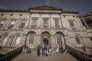 students exiting the Law Library building in Old College quad