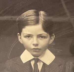 A close up of the boy from the former photograph looking straight into the camera. 
