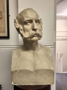 Plaster-cast bust of a man sporting a thick moustache and mutton chops