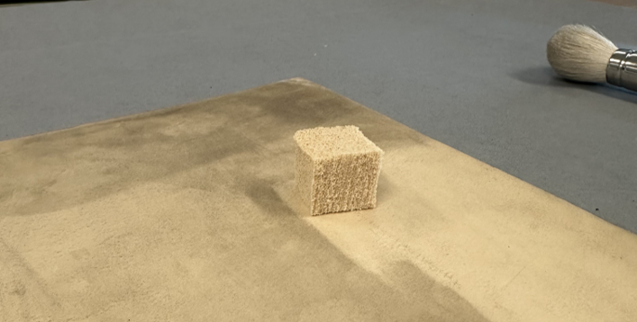 smoke sponge on top of a piece of card. Half has been cleaned