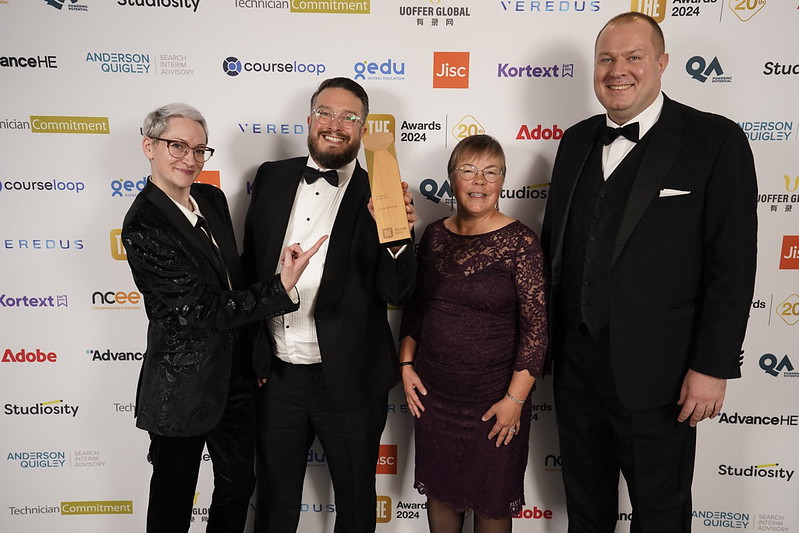 Members of the Library Research Support team standing with the award.