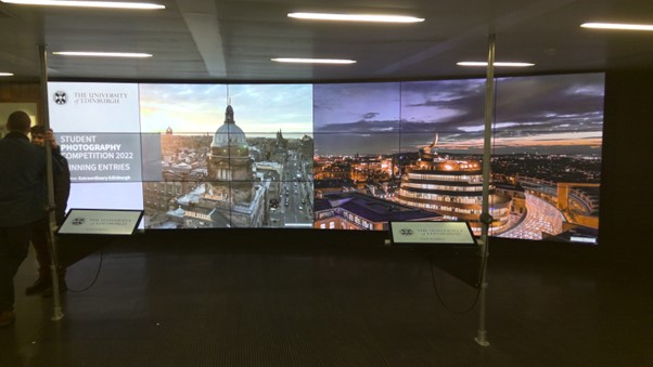 Digital wall showing images from Student Photography Competition including aerial images of the city and St James Quarter