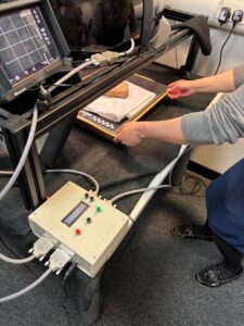 Library staff member positions a piece of cuneiform tablet for digital photography
