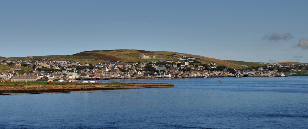 A photograph of Stromess - looking back from the ferry MV Hamnavoe towards Stromness Harbour, Mainland Orkney, Scotland.